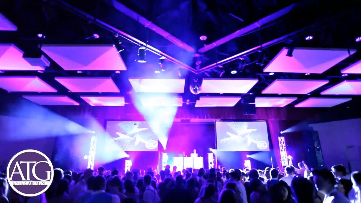 Moving-head beams over a packed dance floor