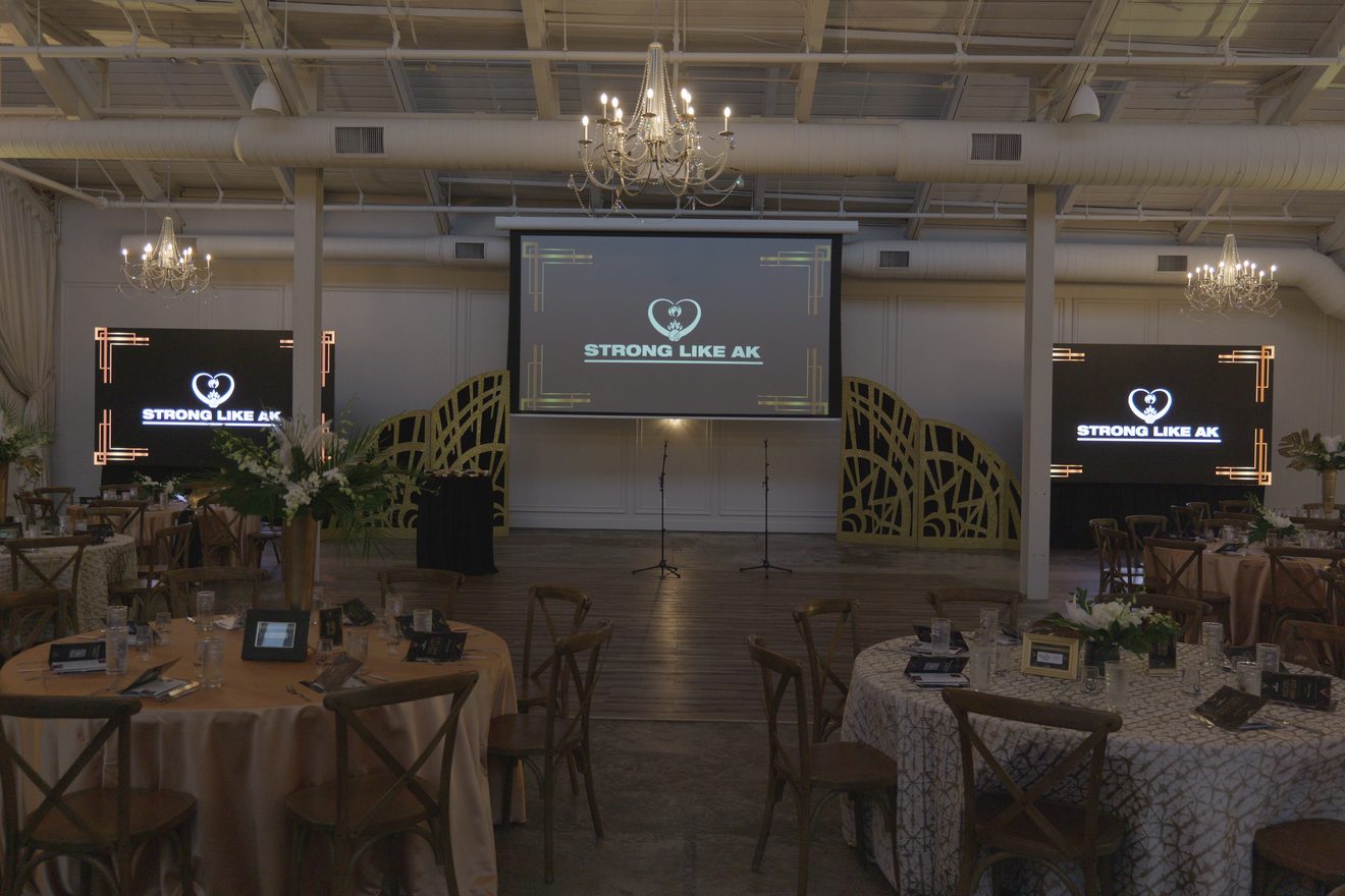 ATG projection screen with two side TVs set for a charity benefit at The Casey