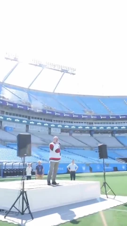 Stage, speakers and podium set on the field at Bank of America Stadium
