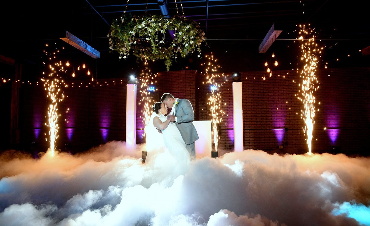 Couple's first dance on a cloud of low fog at an ATG wedding