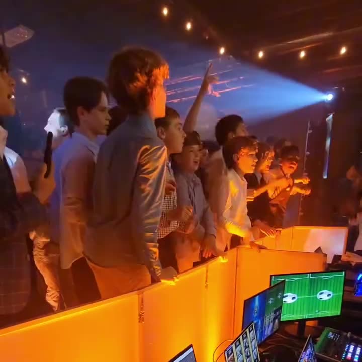 Teen boys dancing and singing along near the DJ booth