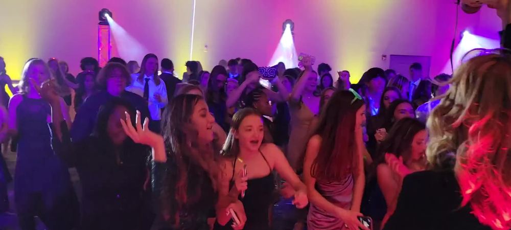 Teens packing the dance floor under ATG moving-head lights