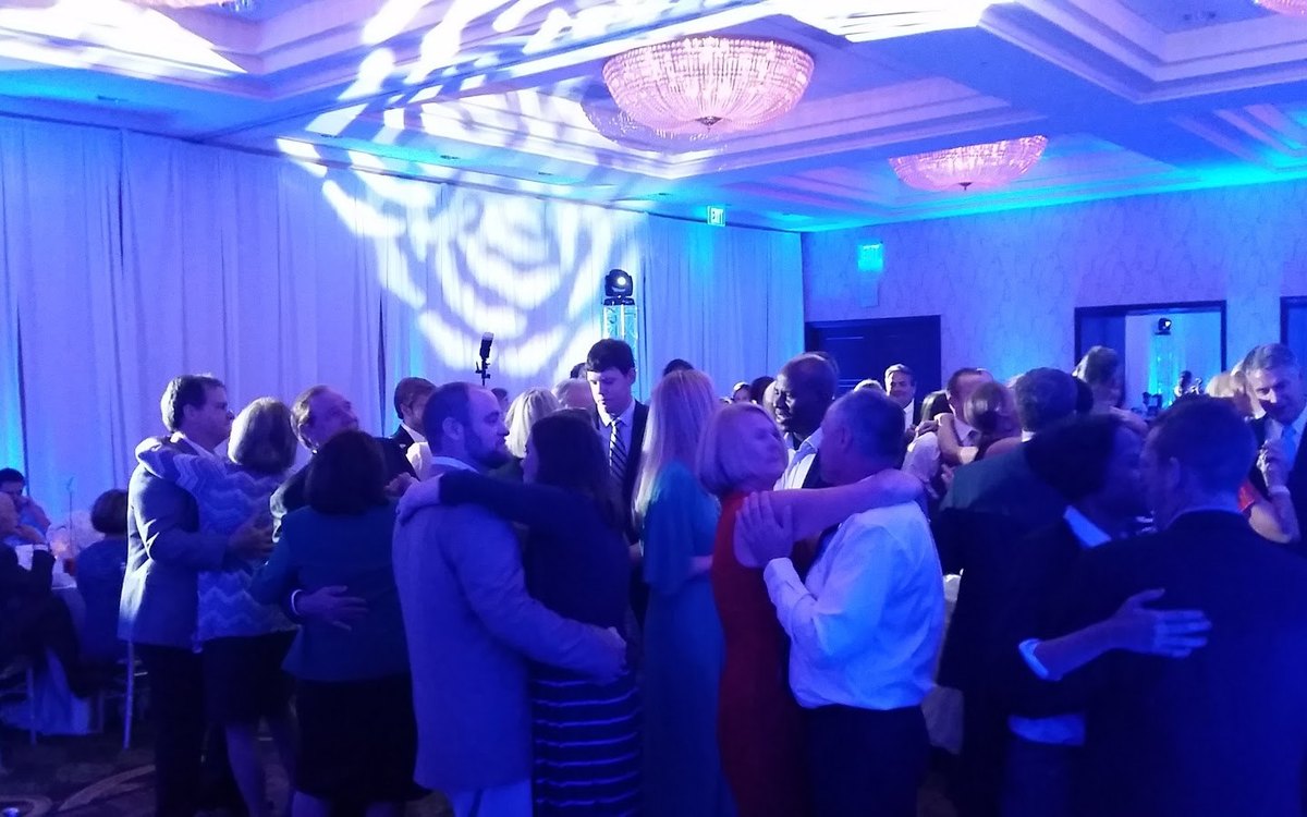 A full dance floor under ATG light patterns and chandeliers at Charlotte Marriott SouthPark