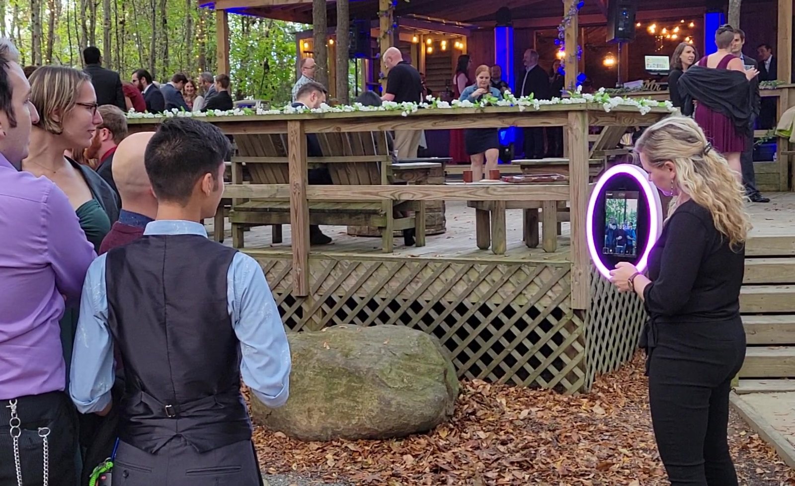 Guests using the roaming social photo booth at an outdoor event