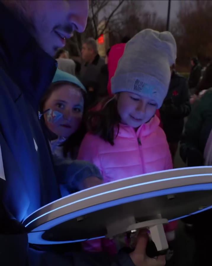 Guests using the ATG AI photo booth at the Chanukah menorah lighting