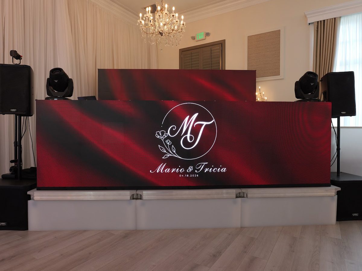 LED video wall DJ booth glowing under a crystal chandelier at an ATG event