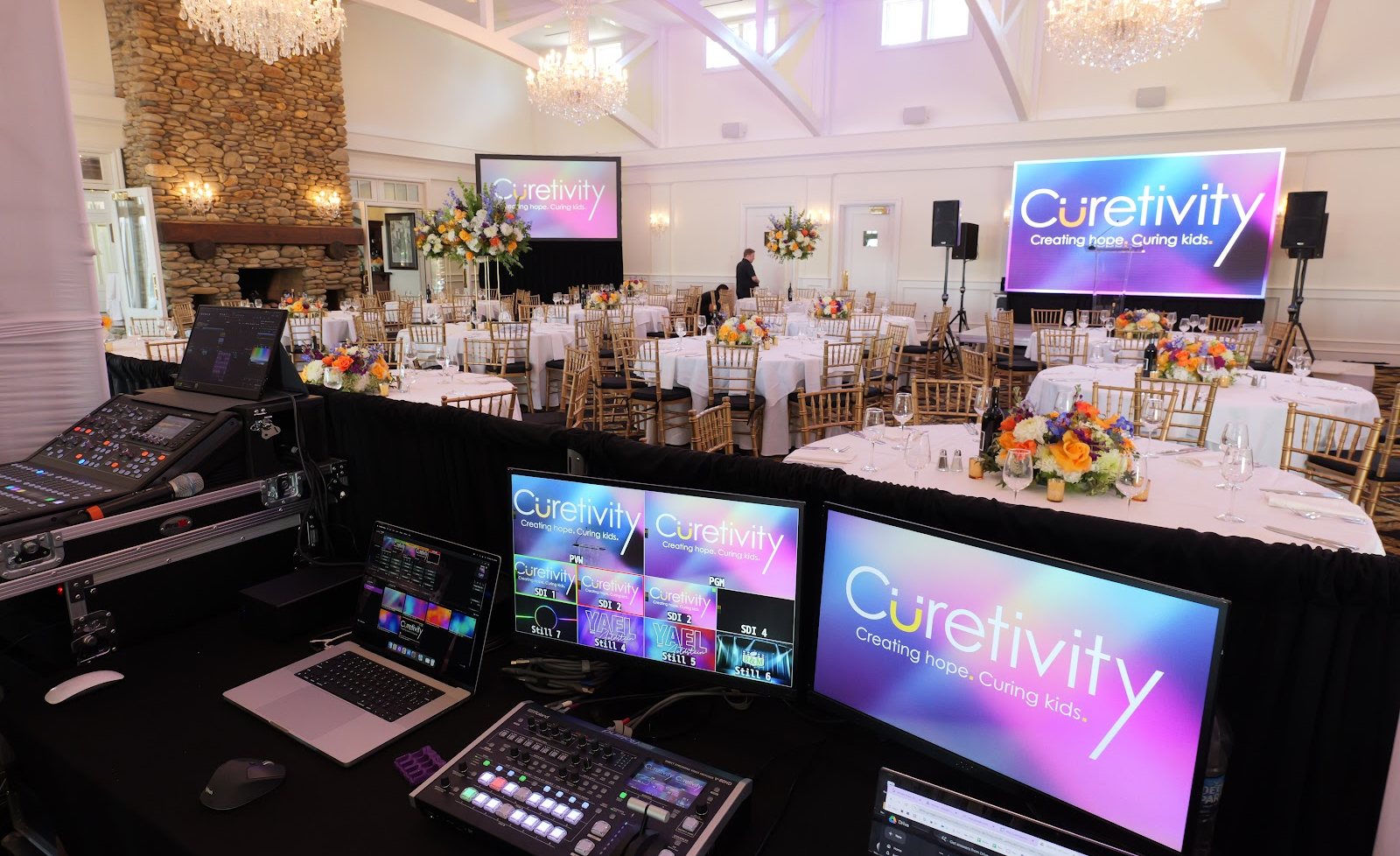 AV control station running custom video content on screens for a corporate event