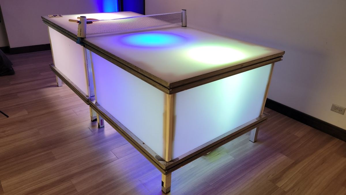 LED ping pong table glowing in a party room