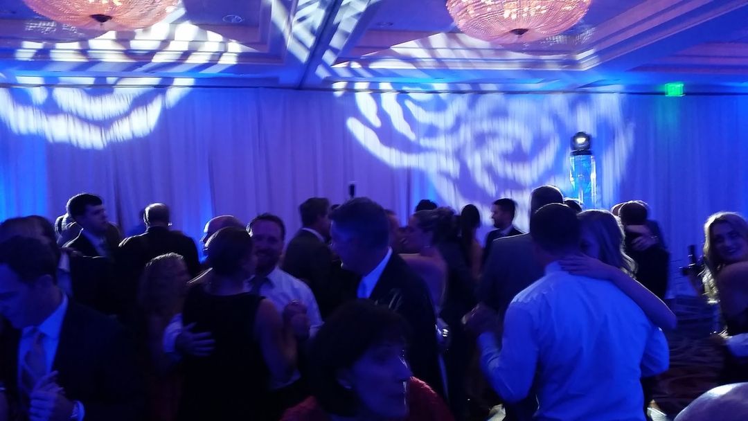 Guests dancing under ATG lighting at a ballroom event