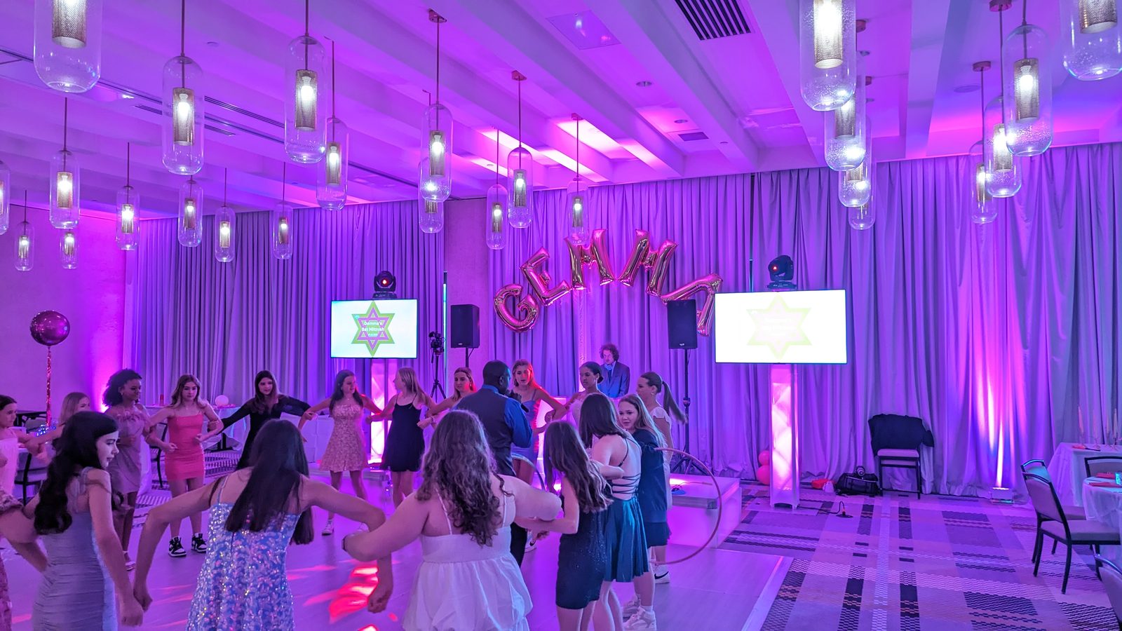 Bat Mitzvah guests dancing under purple lights at Canopy by Hilton SouthPark