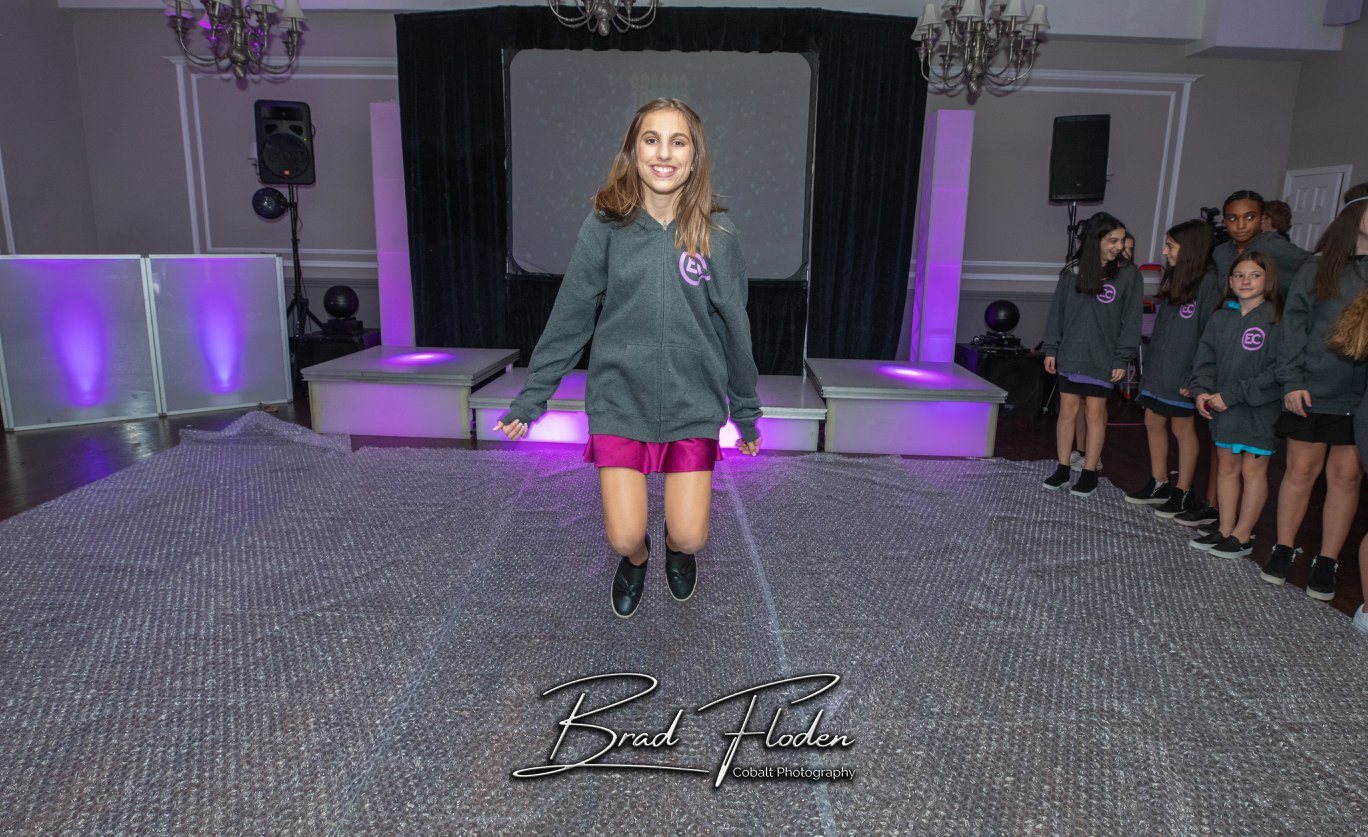 Bat Mitzvah girl walking the bubble wrap dance floor as friends wait their turn